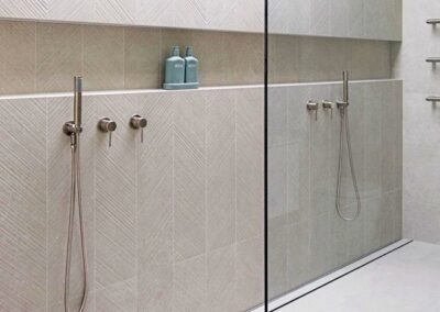 A bathroom with a shower niche and glass shower door.
