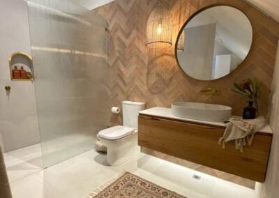 a bathroom with wooden walls and gold plated niche