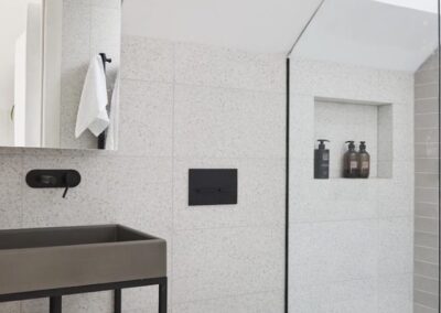 square shower niche in a gray tiled bathroom